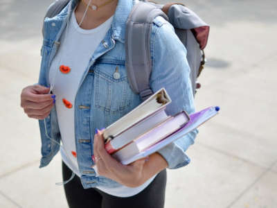 student holding school books